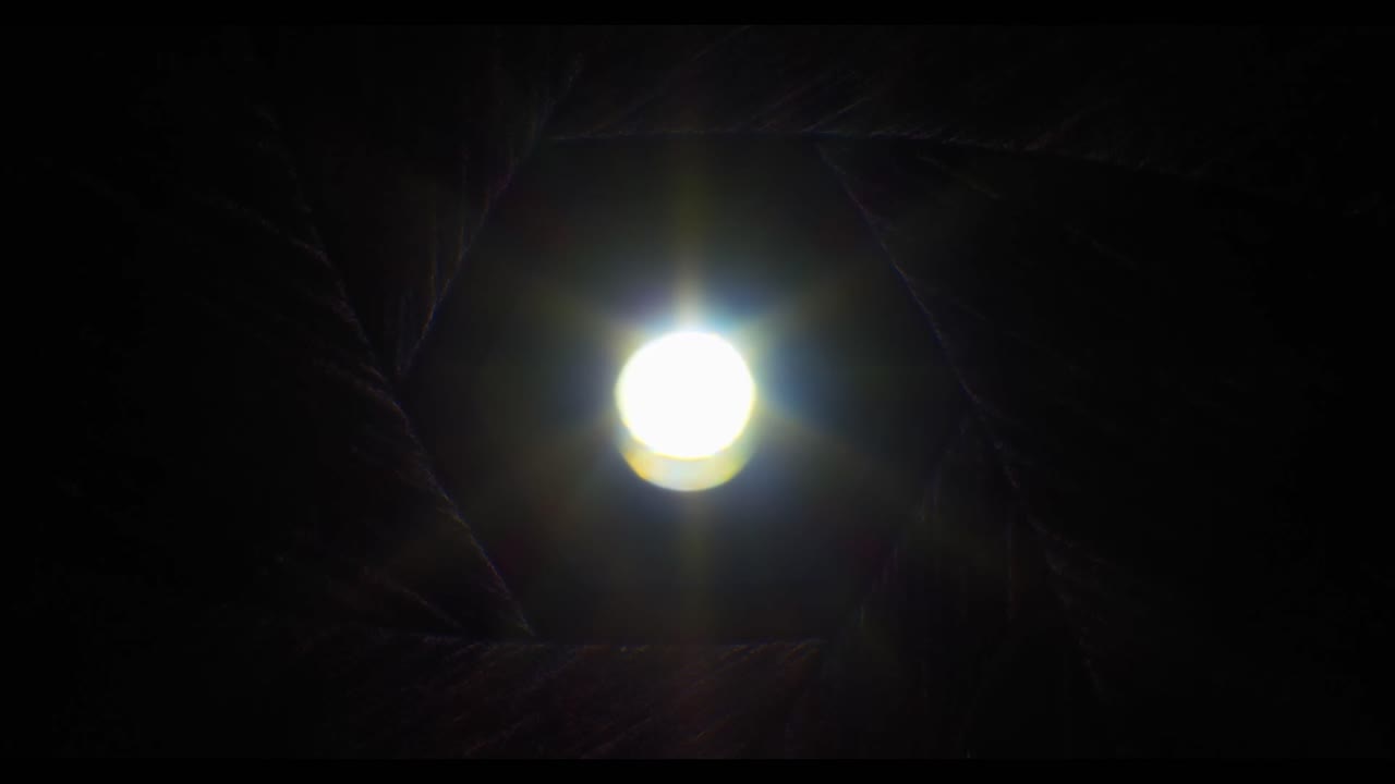 Diaframma dell'obiettivo della fotocamera che si chiude intorno a una luce intensa