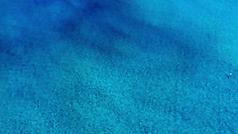 beautiful tones of a blue and clear ocean shot from above