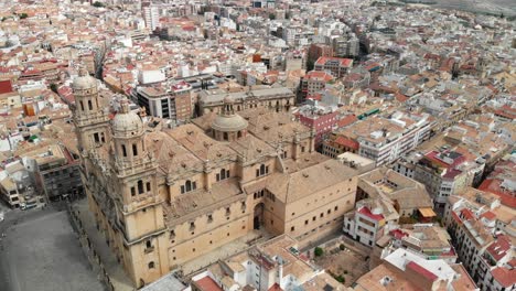 Spain-Jaen-Cathedral,-Catedral-de-Jaen,-flying-shoots-of-this-old-church-with-a-drone-at-4k-24fps-using-a-ND-filter-also-it-can-be-seen-the-old-town-of-Jaen