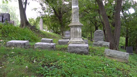 old cemetery panning shot of tombstones in a graveyard with trees 4k