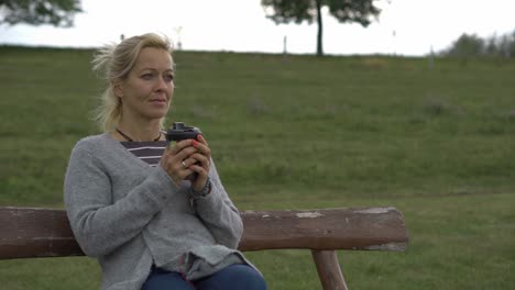 girl drinking hot tea in windy weather