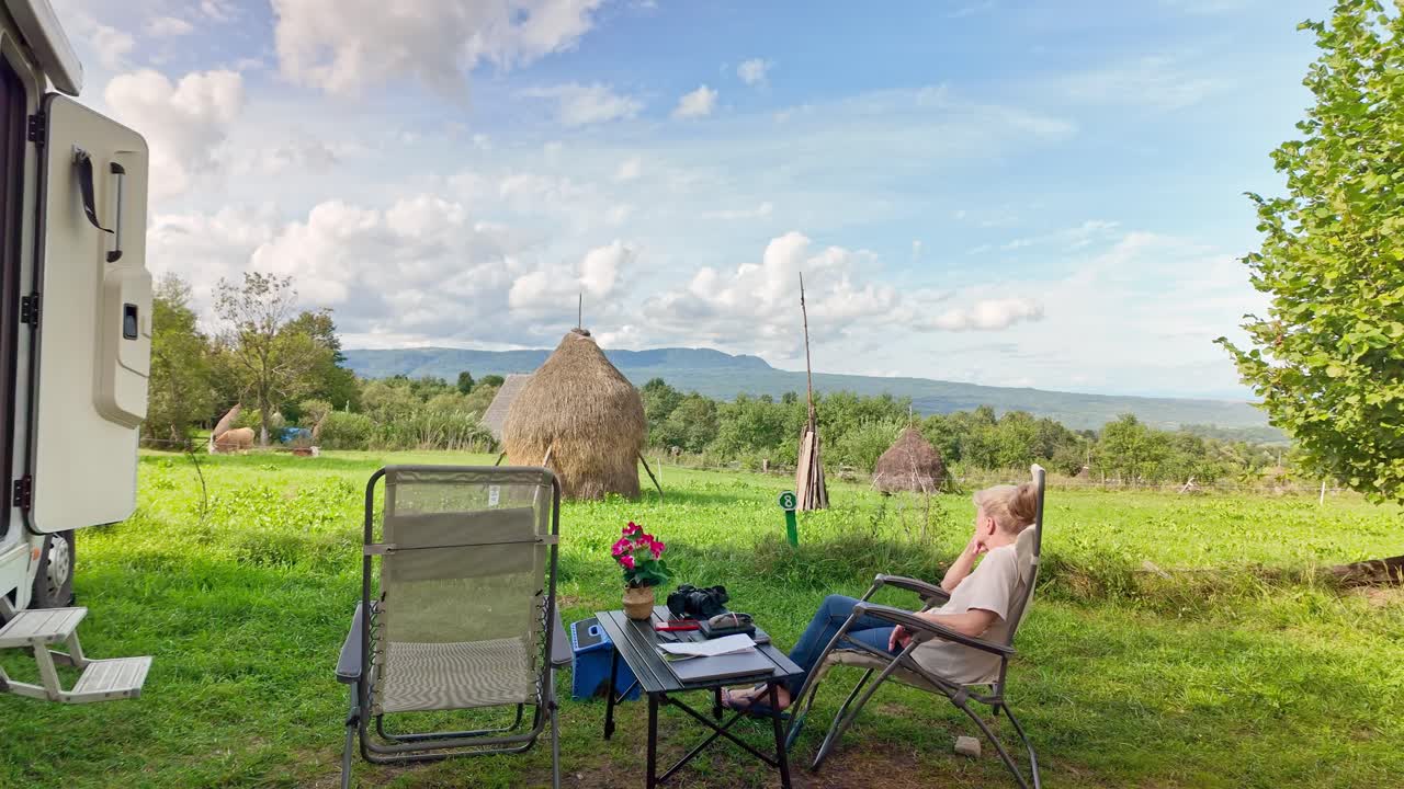 Woman traveller enjoys scenic landscape on motorhome road trip holiday