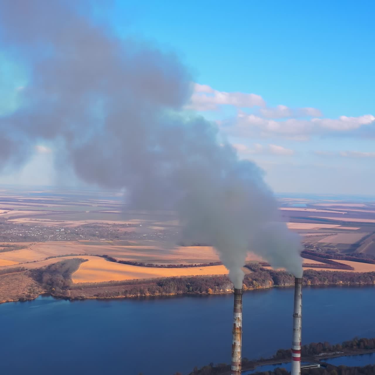 Power plant by the river. Large power plant near a big river