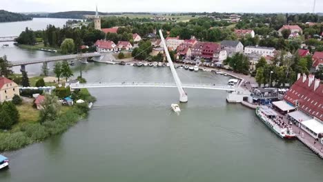 the touristic city in warmian masurian with blue sea and tiny ships and yachts in summer, mikolajki, poland