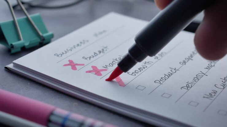 Hand drawn red cross on notepad