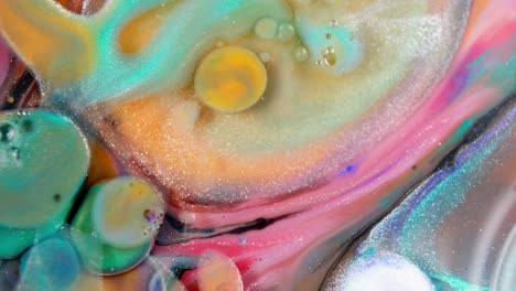 Bubble-bursting-in-abstract-colorful-solution-of-liquid-watercolor-ink