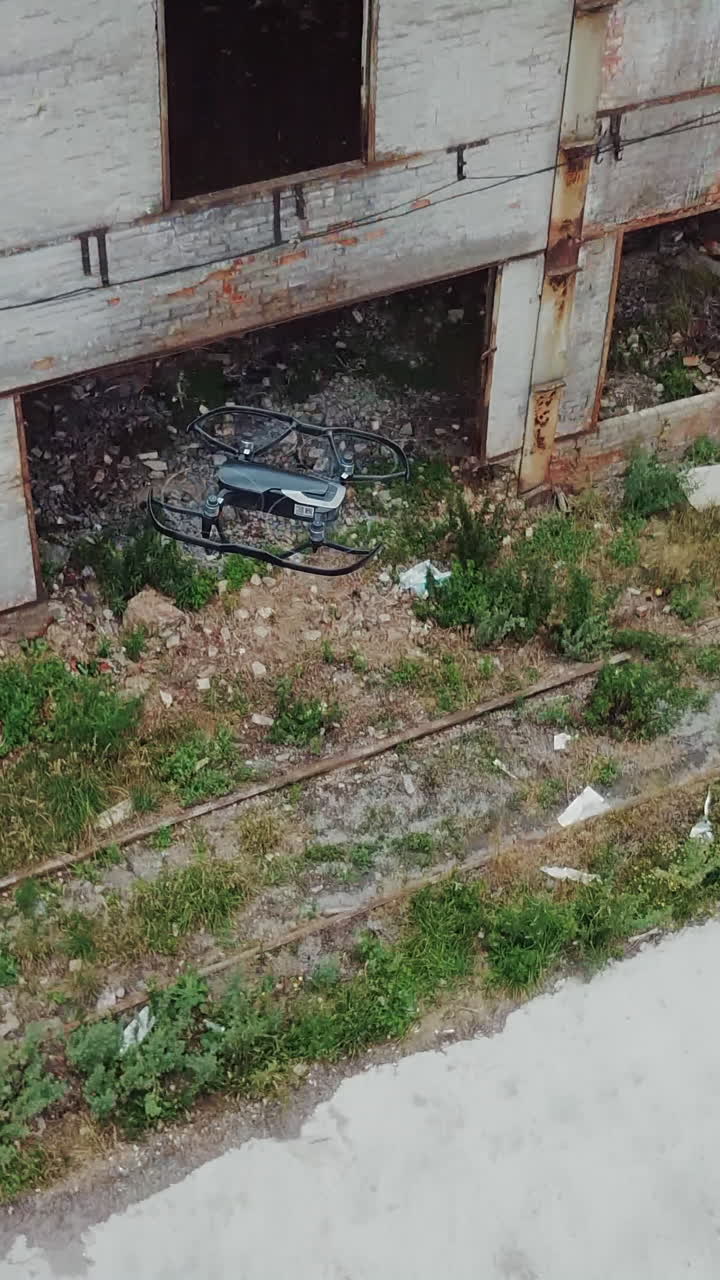 Drone flies over an abandoned factory. Aerial view of abandoned industrial buildings.. Vertical video