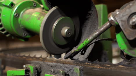 metalwork workshop, bandsaw blade sharpening in closeup slow motion with sparks