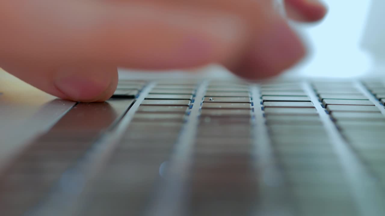 Men's fingers print text on the keyboard, close -up, selective focus, chamber movement