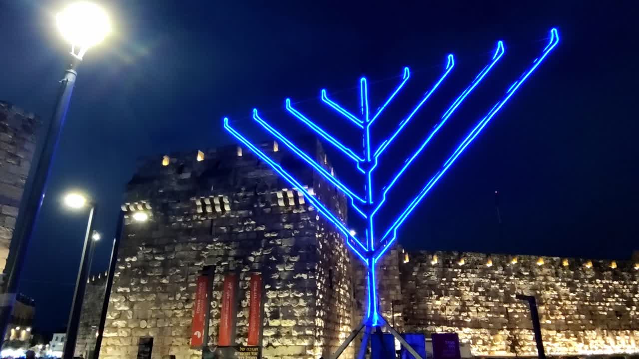 Modern Blue Neon Menorah in Front of Jerusalem's Old City Walls