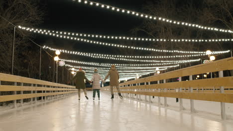 family ice skating at night