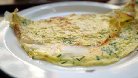 easy breakfast, spinach-and-cheese omelet served in a white plate