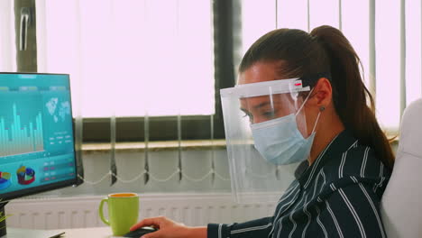 close up of businesswoman wearing protection mask on desk office