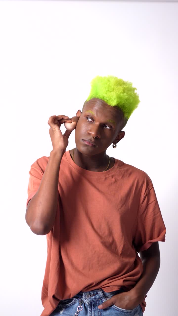 Man with green hair wearing an orange t-shirt