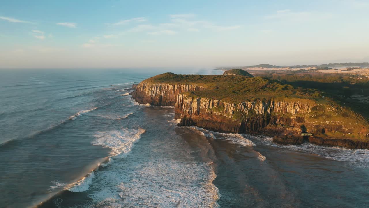 Tropical beach rocky cliffs on atlantic ocean at sunrise