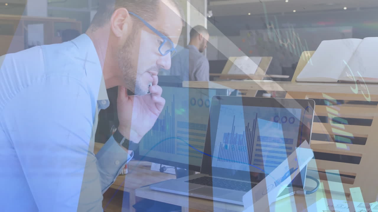 man reviewing charts on laptop in business office, with floating bar and line chart graphics