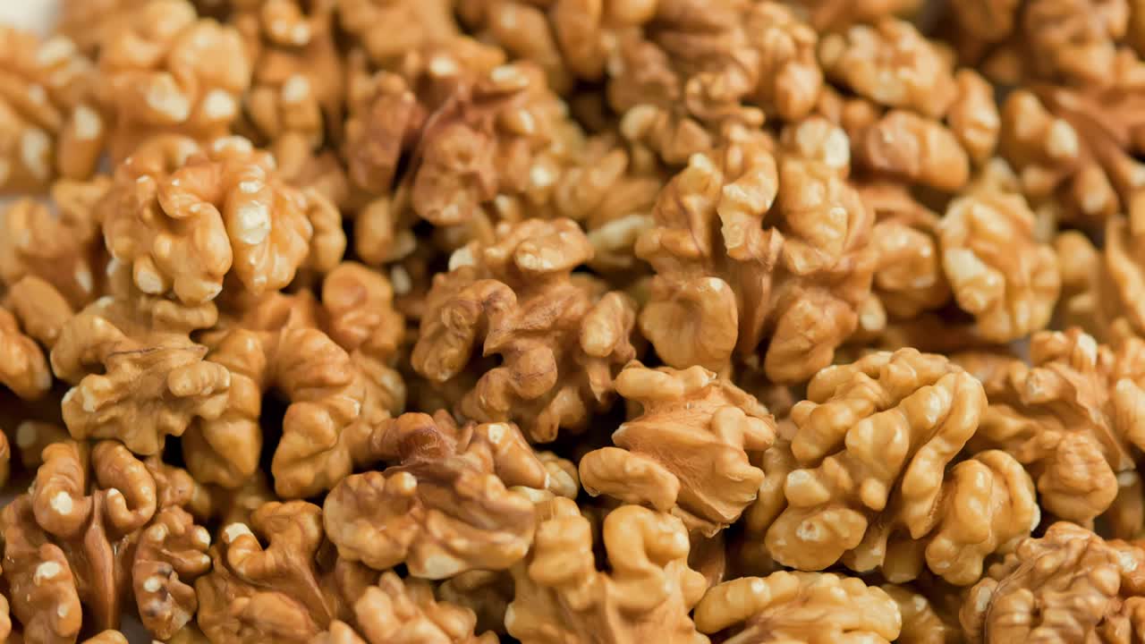 looped spinning walnuts without the shell close-up full frame background