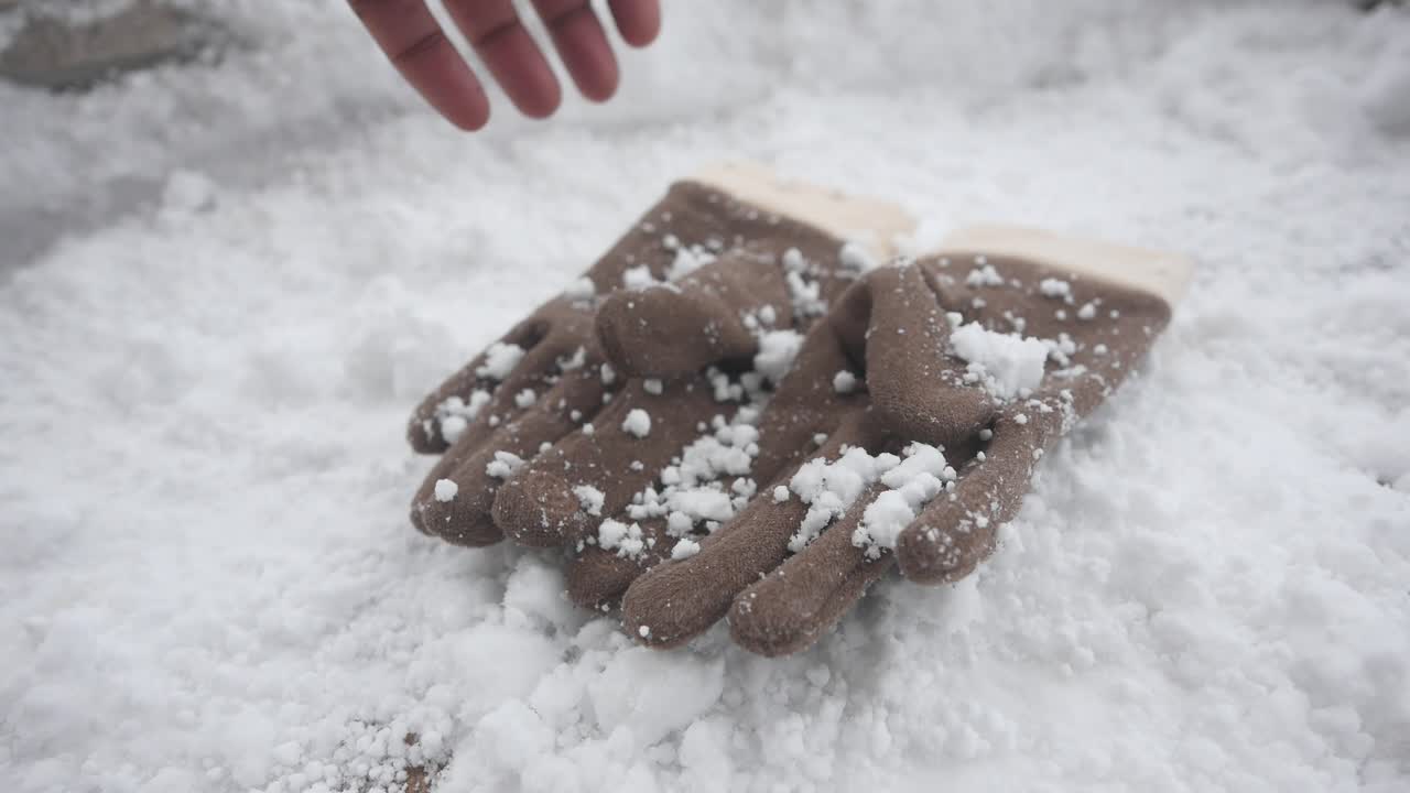 Gloved Hand Interacting with Snow