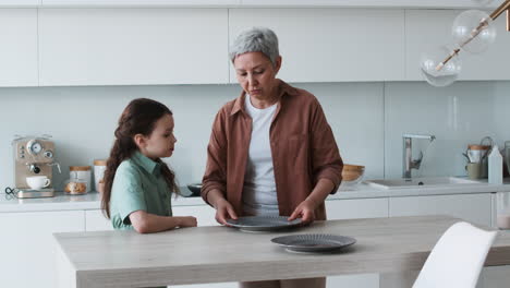 Oma-Und-Mädchen-Decken-Den-Tisch