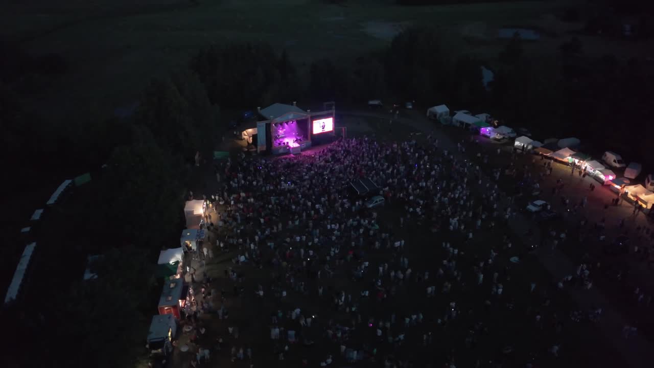 Drone shot of a small concert at night time
