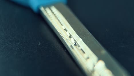 a close up macro slide shot of a metal house key, studio lighting, slow motion, 120 fps, full hd