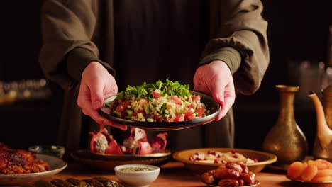 woman serving tabbouleh salad