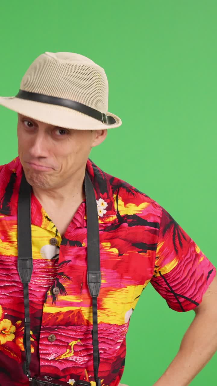 Tourist pointing and smiling on green screen background