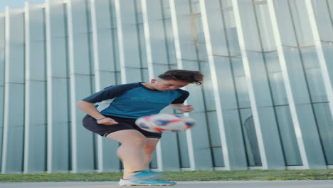 female soccer player juggling a ball outdoors on sidewalk