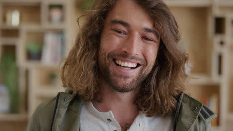 close up portrait of happy young student man laughing enjoying relaxed lifestyle handsome caucasian male with long hair real people series