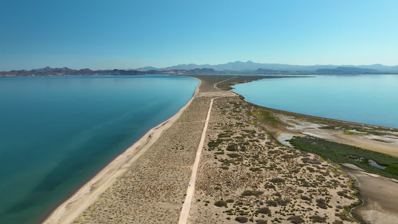 Aerial view following sandbanks on the coastline of La Paz, sunny day in Mexico