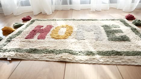 bohemian rug with tassels and 'home' word