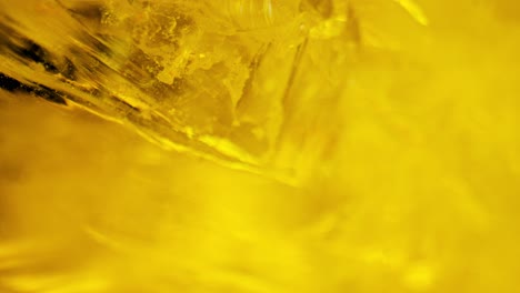 crystal clear quartz glistening under yellow light, captured through smooth panning and macro lens for mesmerizing details