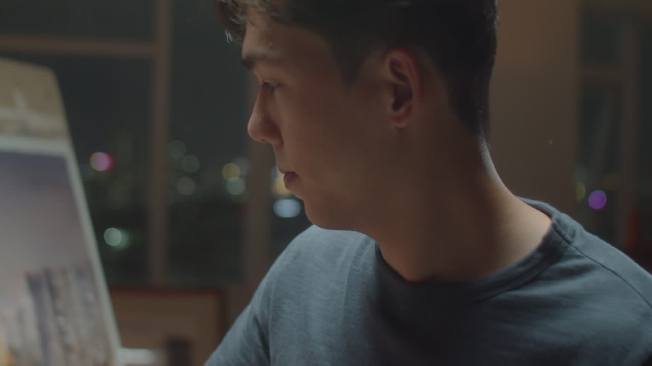 Male Artist Painting Night City on Canvas