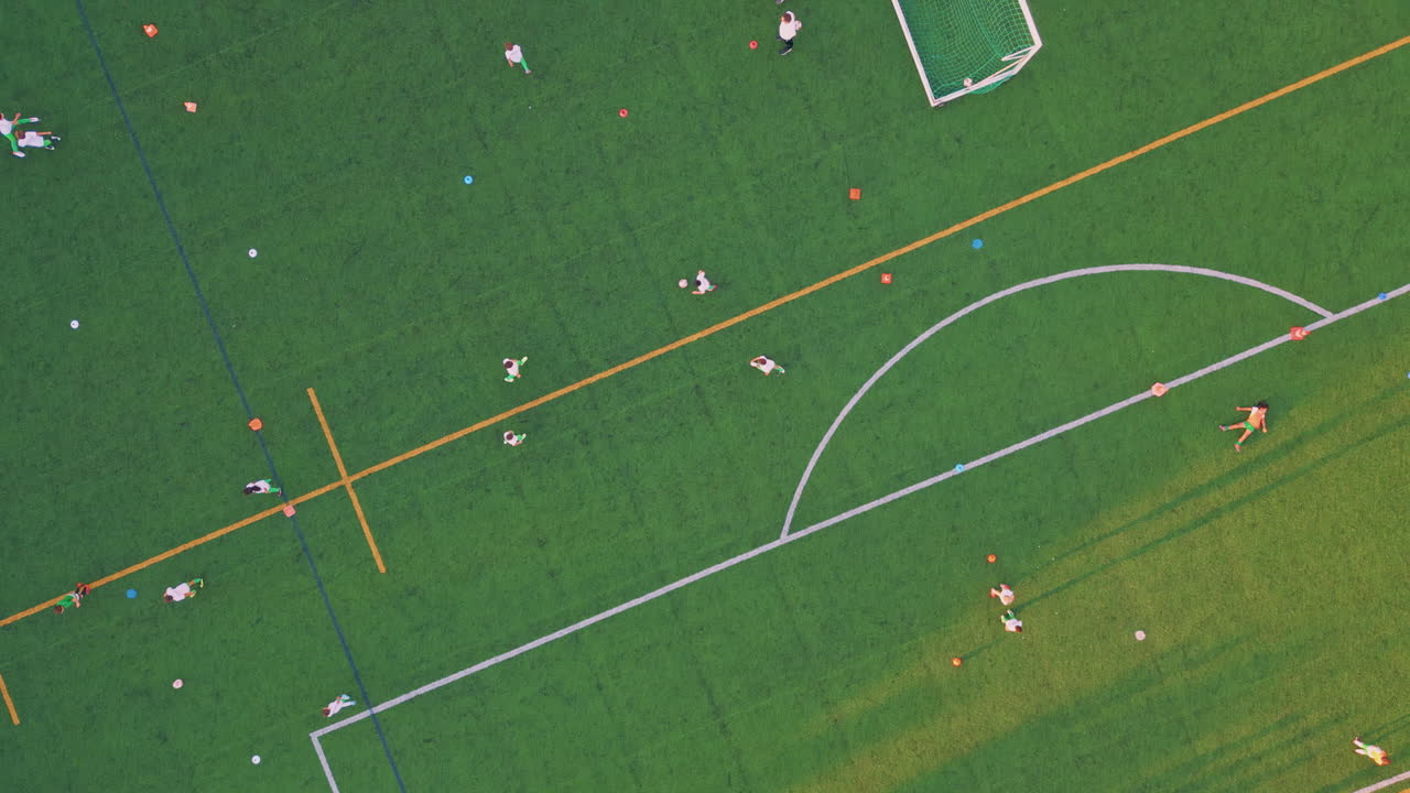 Drone grass soccer field with diverse people sunny evening. Modern town stadium