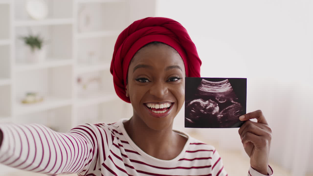Happy Pregnant Woman Showing Ultrasound Photo