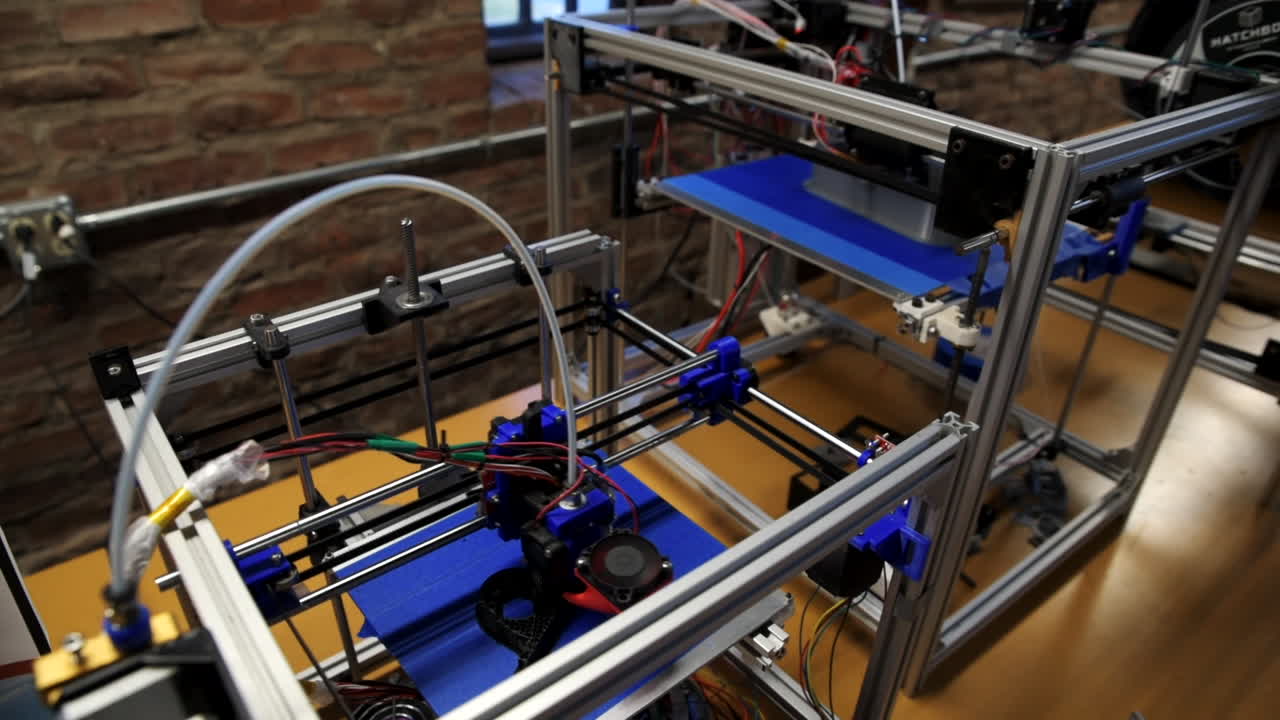 High angle view of two 3D printers in a school makerspace printing student CAD designs