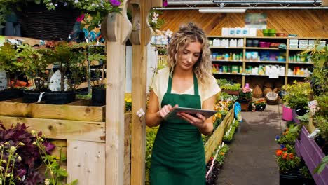 female florist using digital tablet