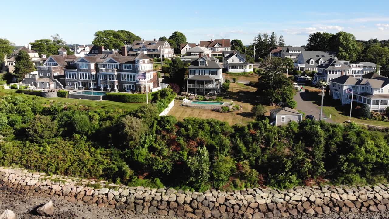 Aerial view over the Hingham Crow Point Neighborhood full of luxurious houses and villa real estate on a beautiful sunny day, tracking shot sideways