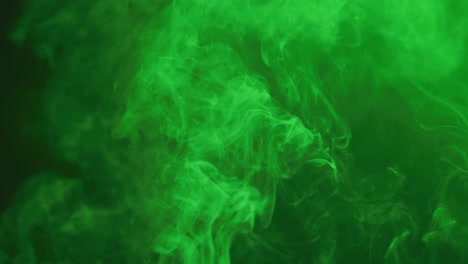 Video-of-white-smoke-with-green-light-moving-on-black-background