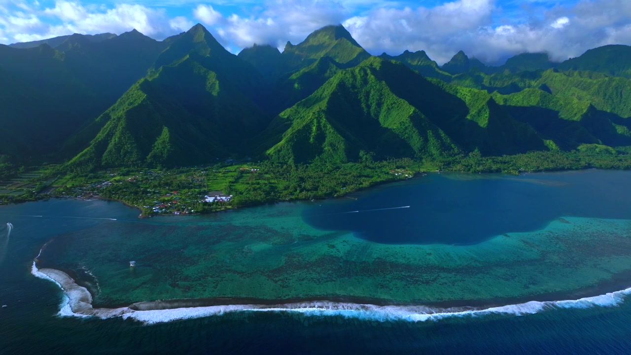 Teahupo'o surf waves sunny blue sky South Pacific Ocean coral reef aerial drone Tahiti French Polynesia harbor view landscape judge tower tour boats jet skis island Passe Havea volcano peaks backwards