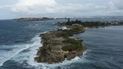 push in aerial over the former fortifications and leper colony of isla de cabra, puerto rico