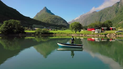 Woman-on-the-boat-catches-a-fish-on-spinning-in-Norway.