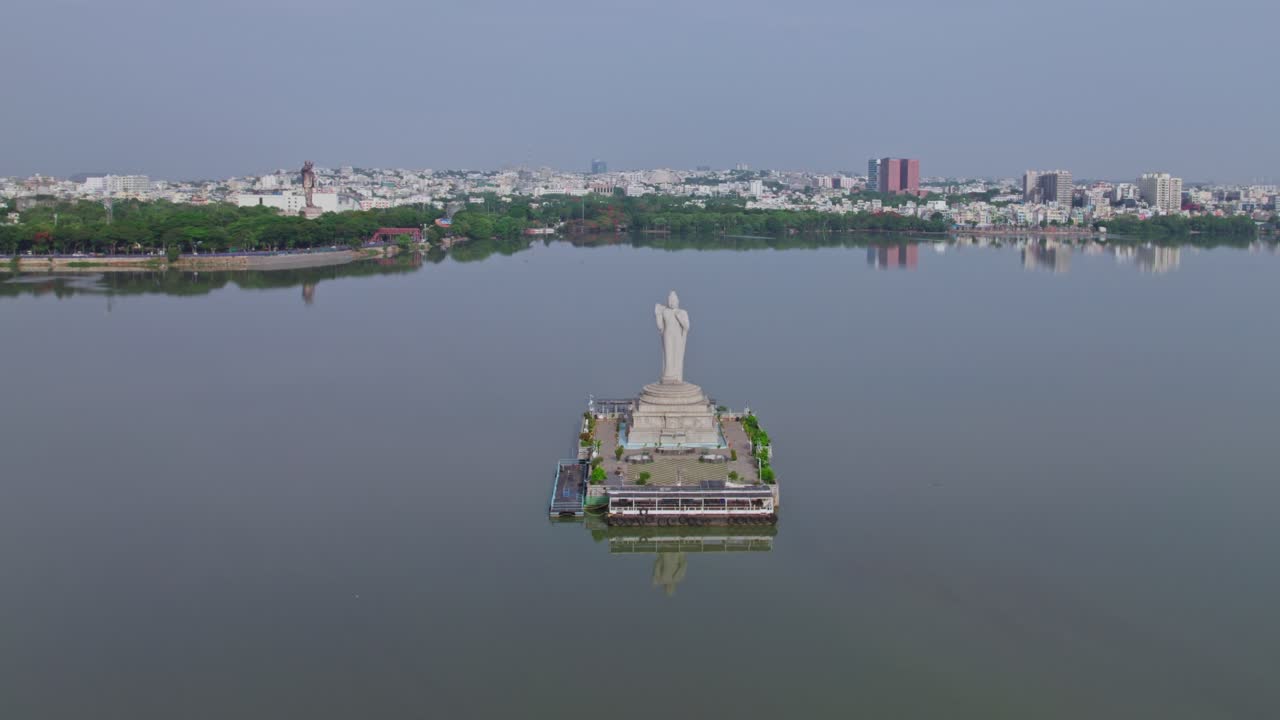 buddha statue, ambedkar statue with buildings reflections on hussain sagar lake at tank bund, Khairtabad, hyderabad, telangana, india. day time, moving down, drone shot, 4k.