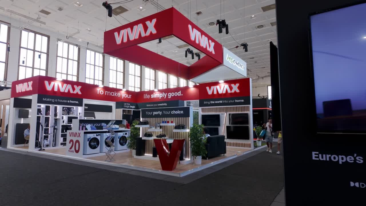 Exhibition hall at IFA Berlin, showcasing the latest in consumer and home electronics, with visitors exploring the various displays and booths.