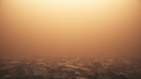moving over rocky floor in amber hazy fog background loop