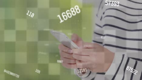 Animation-of-multiple-changing-numbers-over-mid-section-of-woman-using-a-smartphone