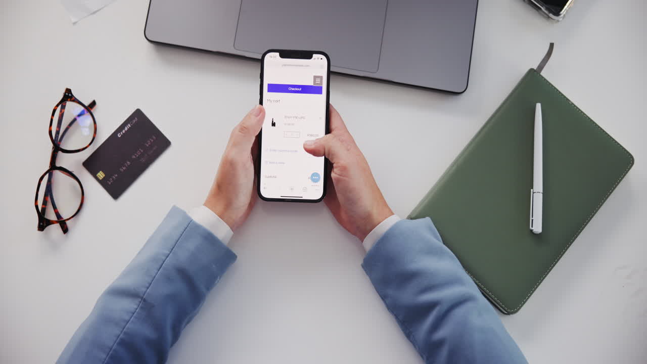Person using a phone for online shopping on a table
