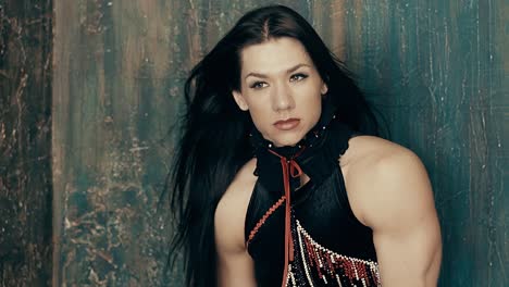 Girl-transsexual-athletic-build-posing-against-the-wall-her-hair-is-developing-with-a-wind-close-up-portrait