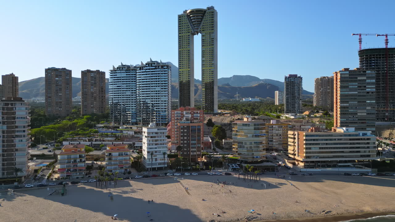 Aerial drone view of the buildings along the coastline and the sea in Benidorm, Spain in daylight