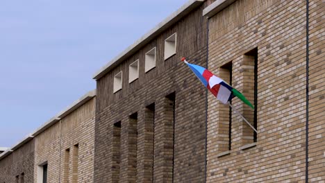 contemporary facades with flag of national veterans day to commemorate and draw attention to the military service of dutch veteran community